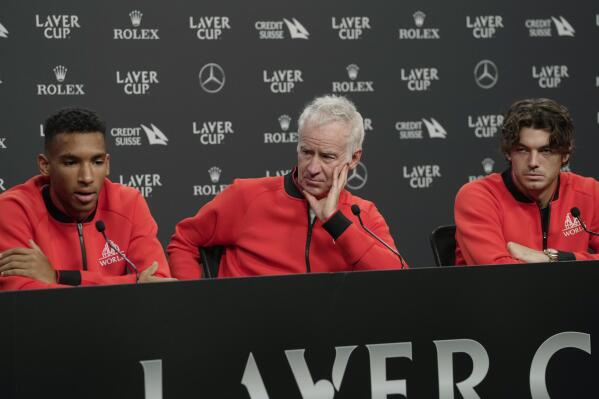 FILE - From left, Felix Auger-Aliassime, of Canada, captain John McEnroe and USA's Taylor Fritz attend a press conference ahead of the Laver Cup tennis tournament at the O2 in London, Thursday, Sept. 22, 2022. ohn McEnroe and Bjorn Borg will return as Laver Cup captains this year, when the men’s tennis team event moves to Canada for the first time. (AP Photo/Kin Cheung, File)