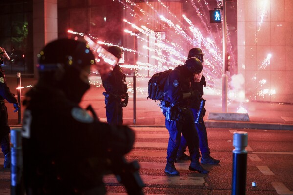 Riot police face off demonstrantors on the third night of protests sparked by the fatal police shooting of a 17-year-old driver in the Paris suburb of Nanterre, France, Thursday, June 29, 2023. The June 27 shooting of the teen, identified as Nahel, triggered urban violence and stirred up tensions between police and young people in housing projects and other neighborhoods. (AP Photo/Aurelien Morissard)