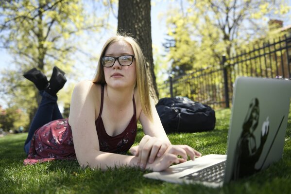 
              ADVANCE FOR USE SATURDAY, JUNE 2 - In this May 8, 2018 photo, Emily Murray 19, studies at Farrand Field for her last final as she finishes her first semester as a junior at the University of Colorado Boulder in Boulder, Colo. Emily entered foster care at 14 after years of depression, the result of living in an abusive home, she said. With the help of a former teacher, Emily finished high school and now attends college. (Joe Amon/The Denver Post via AP)
            