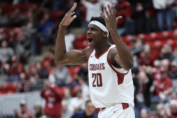 Washington State center Rueben Chinyelu celebrates his dunk against California during the second half of an NCAA college basketball game Thursday, Feb. 15, 2024, in Pullman, Wash. (AP Photo/Young Kwak)