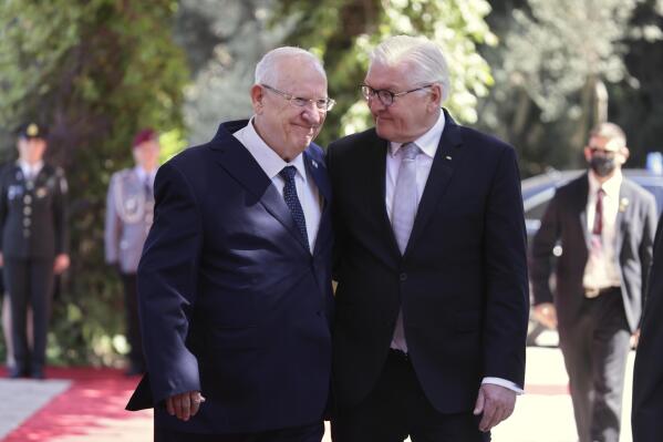 Israeli President Reuven Rivlin, left, walks with German President Frank-Walter Steinmeier at the president's residence in Jerusalem, Thursday, July 1, 2021. (AP Photo/Tsafrir Avayov)