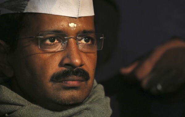 Aam Aadmi Party, or Common Man's Party, leader Arvind Kejriwal listens to a speaker during a public meeting in New Delhi, India, Dec. 27, 2013. The anti-corruption crusader was arrested on Thursday, March 21, 2024, by a federal agency that accused his party and ministers of accepting 1 billion rupees ($12 million) as bribes from liquor contractors nearly two years ago, a top leader of his party said. (AP Photo/Manish Swarup, File)