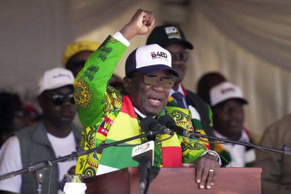 Zimbabwean President Emmerson Mnangagwa greets party supporters at a campaign rally in Harare, Wednesday, Aug. 9, 2023. Mnangagwa addressed thousands of supporters in a speech laden with calls for peace, days after his supporters were accused of stoning an opposition activist to death ahead of general elections set for Aug. 23. (AP Photo/Tsvangirayi Mukwazhi)