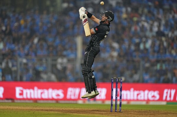 New Zealand's Mitch Santner bats during the ICC Men's Cricket World Cup first semifinal match between India and New Zealand in Mumbai, India, Wednesday, Nov. 15, 2023. (AP Photo/Rajanish Kakade)