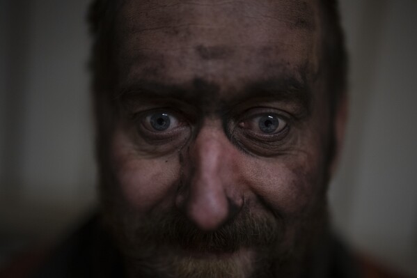 Coal miner Jonny Sandvoll poses for a portrait in the break room of the Gruve 7 coal mine, the last Norwegian mine in one of the fastest warming places on earth in Adventdalen, Norway, Jan. 9, 2023. (AP Photo/Daniel Cole)