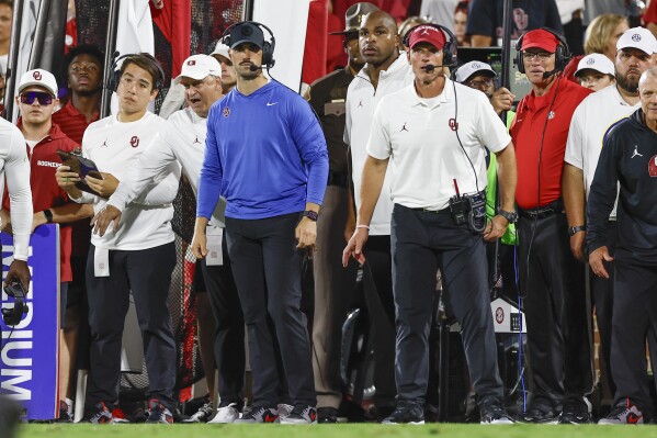 Oklahoma co-defensive coordinator Zac Alley, left, and head coach Brent Venables, right, watch their team play against Tennessee during the first half of an NCAA college football game, Sept. 21, 2024, in Norman, Okla. (AP Photo/Alonzo Adams, File)