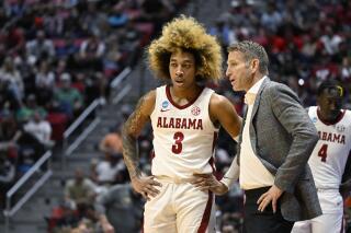 Alabama head coach Nate Oats, right, talks with guard JD Davison (3) during the first half of a first-round NCAA college basketball tournament game against Notre Dame, Friday, March 18, 2022, in San Diego. (AP Photo/Denis Poroy)