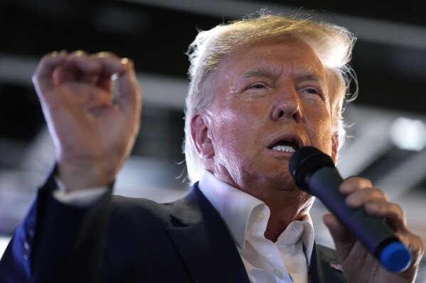 FILE - Republican presidential candidate former President Donald Trump speaks to supporters during a visit to the Iowa State Fair, Saturday, Aug. 12, 2023, in Des Moines, Iowa. Trump’s response this week to his fourth criminal indictment in five months follows a strategy he has used for years against legal and political opponents: relentless attacks, often infused with language that is either overtly racist or is coded in ways that appeal to racists. (AP Photo/Charlie Neibergall, File)