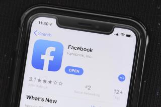 FILE - In this July 30, 2019, file photo, the social media application, Facebook is displayed on Apple's App Store in Chicago. On Wednesday, July 17, 2020, Several civil-rights and other advocacy groups are calling on large advertisers to stop Facebook ad campaigns during July 2020 because they say the social network isn’t doing enough to curtail racist and violent content on its platform. (AP Photo/Amr Alfiky, File)
