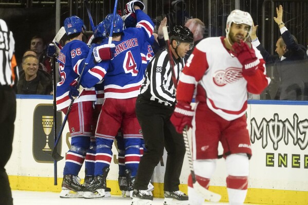 New York Rangers players celebrate a third and winning goal during an NHL game against the Detroit Red Wings Wednesday, Nov. 29, 2023, in New York. (AP Photo/Bebeto Matthews)