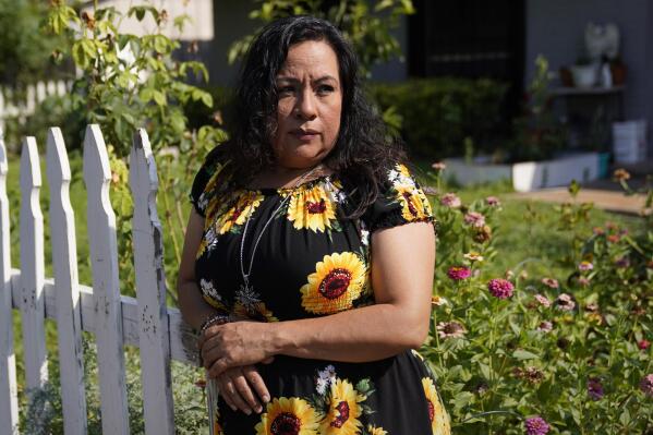 Francisca Acuña, who works as an activist around climate issues and used to teach people to buy flood insurance, poses for a photo at her home, Thursday, July 14, 2022, in Austin, Texas. As climate change drives stronger and wetter hurricanes, and increases flood risk in many parts of the country, FEMA has updated its flood insurance program to more accurately reflect risk, but also make the program more solvent. Flood insurance for Acuna was about $450 a year under FEMA's old pricing system, and now nearly $1,900 under the new one. (AP Photo/Eric Gay)