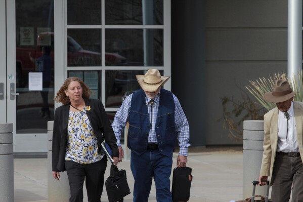 FILE - George Alan Kelly exits the Santa Cruz County Courthouse with defense attorney Kathy Lowthorp after the first day of his trial in Santa Cruz County Superior Court Friday, March 22, 2024 in Nogales, Ariz. Jurors in the case of the Arizona rancher Kelly charged with fatally shooting a migrant on his property visited the scene of the killing as the third week of the trial wrapped up. The jurors on Thursday, April 11, 2024, viewed various locations at Kelly's ranch, as well as a section of the U.S.-Mexico border. (Angela Gervasi/Nogales International, via AP, File)