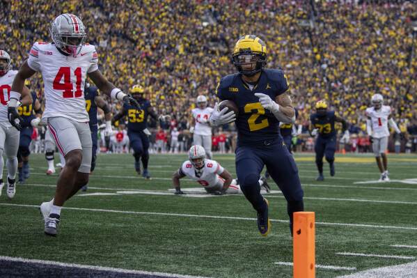 Michigan running back Blake Corum runs to the end zone to score a touchdown during the second half of an NCAA college football game against Ohio State, Saturday, Nov. 25, 2023, in Ann Arbor, Mich. Michigan won 30-24. (AP Photo/David Dermer)