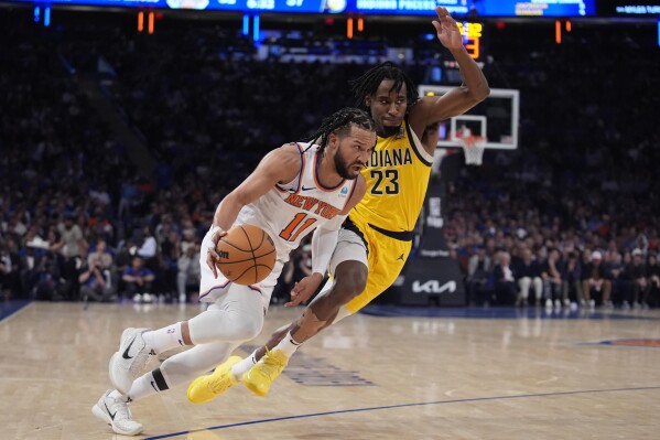 New York Knicks' Jalen Brunson (11) drives past Indiana Pacers' Aaron Nesmith (23) during the first half of Game 1 in an NBA basketball second-round playoff series, Monday, May 6, 2024, in New York. (AP Photo/Frank Franklin II)