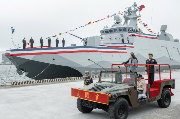 In this photo released by the Taiwan Presidential Office, Taiwan's President Tsai Ing-wen inspects the commissioning of two new navy ships in the northern Taiwan port of Suao on Tuesday, March 26, 2024. Taiwan has commissioned two new navy ships as a safeguard against the rising threat from China, which has been ratcheting up its naval and air force missions around the island that it claims as its own territory to be annexed by force if necessary. The pair of Tuo Chiang class corvettes completes the first order of six of the domestically produced catamarans with stealth capabilities. (Taiwan Presidential Office via AP)