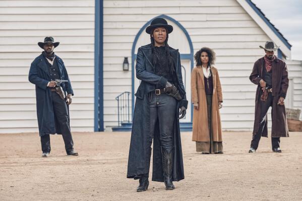 This image released by Netflix shows Regina King, center, from the film "The Harder They Fall." (David Lee/Netflix via AP)