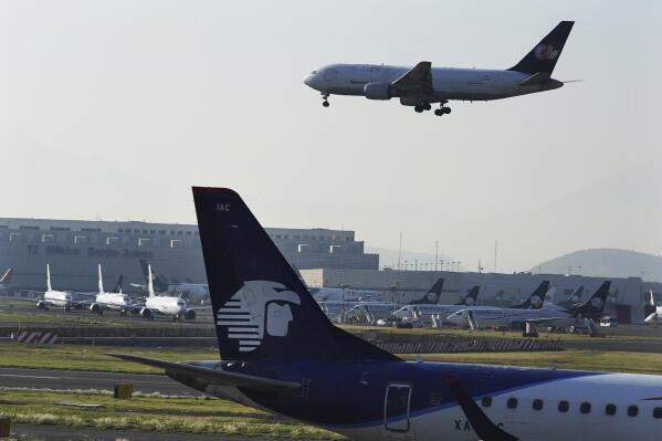 FILE - Passenger planes land at Benito Juárez International Airport in Mexico City, May 12, 2022. (AP Photo/Marco Ugarte, Fille)