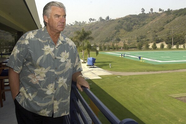 FILE - San Diego Chargers general manager A.J. Smith stares out at the Chargers practice fields from his office balcony, July 9, 2003, in San Diego. Smith, a longtime NFL executive who was the winningest general manager in Chargers history, has died, according to his son on Sunday, May 12, 2024. (Ǻ Photo/Lenny Ignelzi, File)