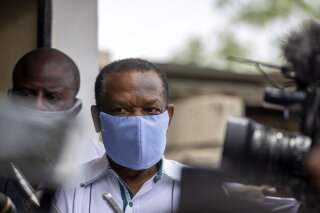 FILE - In this file photo dated Thursday, May 21, 2020, Yves Jean-Bart, president of the Haitian Football Federation, wearing a protective face mask, arrives for a court hearing regarding allegations that he abused female athletes at the country's national training center, in Croix-des-Bouquets, Haiti. In a verdict announced Friday Nov. 20, 2020, the FIFA ethics committee has found Jean-Bart guilty, banned him from the sport for life and fined him dollars 1.1 million, following accusations of systematic sexual abuse of female players. (AP Photo/Dieu Nalio Chery, FILE)