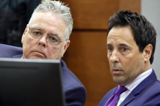 Former Marjory Stoneman Douglas High School School Resource Officer Scot Peterson, left, and defense attorney Mark Eiglarsh watch a video of the shooting during his trial, Thursday, June 8, 2023, at the Broward County Courthouse in Fort Lauderdale, Fla. Peterson is charged with child neglect and other charges for failing to stop the Parkland school massacre five years ago. (Amy Beth Bennett/South Florida Sun-Sentinel via AP, Pool)