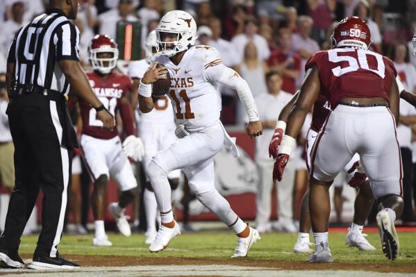 Texas quarterback Casey Thompson (11) runs for a touchdown against Arkansas during the second half of an NCAA college football game Saturday, Sept. 11, 2021, in Fayetteville, Ark. (AP Photo/Michael Woods)