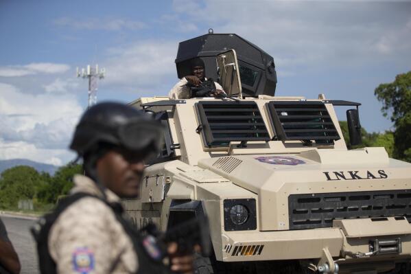 Police officers in an armored vehicle patrol the Varreux fuel terminal in Port-au-Prince, Haiti, Monday, Nov. 7, 2022. Authorities seemed to have gained control of the key fuel terminal a day after a powerful gang leader announced that he was lifting a blockade that has strangled Haiti's capital for nearly two months. (AP Photo/Odelyn Joseph)