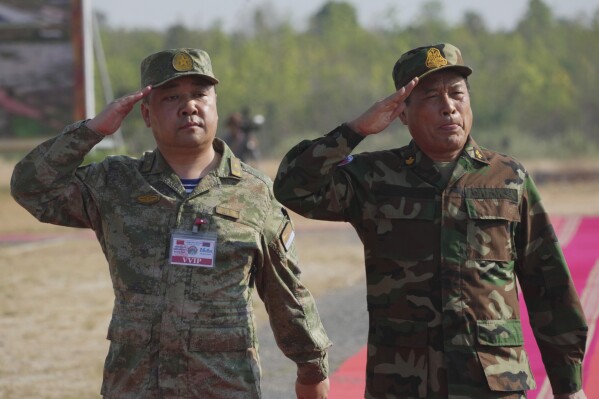 Gao Xiucheng, left, deputy chief of staff of the Southern Theater Commander of the Chinese People's Liberation Army reviews the troops together with Cambodian Gen. Vong Pisen, right, commander-in-chief of Cambodian army as they arrive for the Golden Dragon military exercise in Svay Chok village, Kampong Chhnang province, north of Phnom Penh, Cambodia, Thursday, May 16, 2024. Cambodia and China began half-month long military exercises on Thursday, which come amid growing questions about Beijing's increasing influence in the Southeast Asian nation. (AP Photo/Heng Sinith)