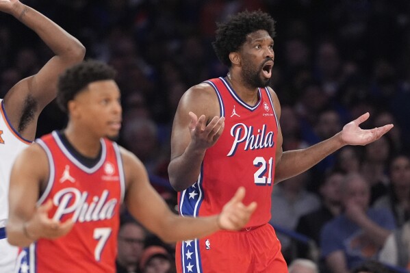 Philadelphia 76ers center Joel Embiid (21) and Kyle Lowry (7) react during the first half in Game 1 of an NBA basketball first-round playoff series against the New York Knicks, Saturday, April 20, 2024, at Madison Square Garden in New York. (AP Photo/Mary Altaffer)