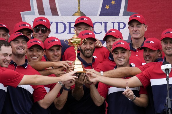 FILE - Team USA players and captains pose with the trophy after the Ryder Cup matches at the Whistling Straits Golf Course Sunday, Sept. 26, 2021, in Sheboygan, Wis. The Americans will try to win for the second straight time outside Rome when the matches start Friday, Sept. 29.(AP Photo/Ashley Landis, File)