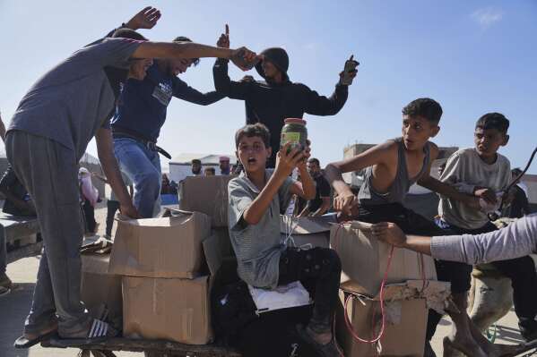 Palestinians carry boxes containing food and humanitarian aid packages delivered by the Gaza Humanitarian Foundation, a U.S.-backed organization approved by Israel, in Rafah, southern Gaza Strip, on Tuesday, May 27, 2025. (AP Photo/Abdel Kareem Hana)