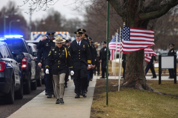 Sioux Falls Police Chief Jon Thum gets escorted to the funeral of Moody County Chief Deputy Ken Prorok on Thursday, Feb. 8, 2024 at Dakota Prairie Playhouse in Madison, S.D.. Moody County Chief Deputy Ken Prorok died in the line of duty during a vehicle chase. (Samatha Laurey/The Argus Leader via AP)