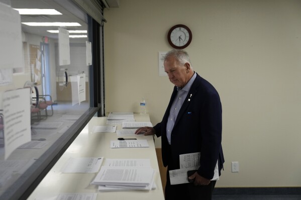 FILE - Interim Nye County Clerk Mark Kampf works in an office where early votes are being counted, Oct. 26, 2022, in Pahrump, Nev. Kampf, top elections official in the rural Nevada county roiled by false claims of widespread election fraud that led to a partial hand-count in the 2022 midterms, is resigning, a county spokesperson confirmed Thursday, Feb. 29, 2024. (APPhoto/John Locher, File)