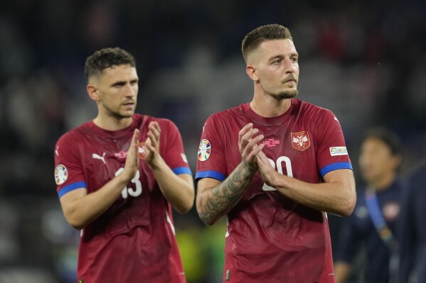 Serbia's Sergej Milinkovic-Savic and Milos Veljkovic applaud fans during a Group C match between Serbia and England at the Euro 2024 soccer tournament in Gelsenkirchen, Germany, Sunday, June 16, 2024. (AP Photo/Andreea Alexandru)