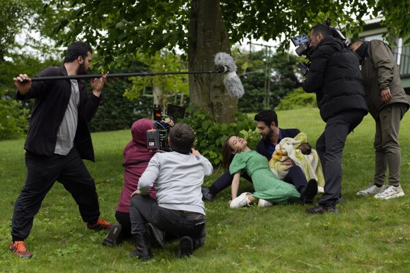 A production team is filming scenes of a Turkish drama with actor Paris Baktas and actress Yagmur Yuksel, Turkey, Tuesday, April 30, 2024. (AP Photo/Khalil Hamra)