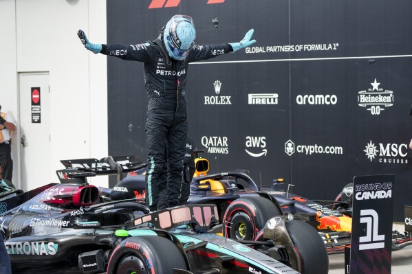 Mercedes driver George Russell, of Britain, celebrates after winning the pole position for the Sunday race in the qualifying session for the Formula 1 Canadian Grand Prix auto race Saturday, June 8, 2024, in Montreal. (Paul Chiasson/The Canadian Press via AP)