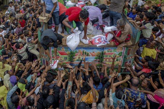 
              FILE- In this Sept. 18, 2017 file photo, Rohingya Muslims, who crossed over from Myanmar into Bangladesh, stretch their arms out to collect food items distributed by aid agencies near Balukhali refugee camp, Bangladesh. Six months after waves of attacks emptied Rohingya villages in Myanmar, sending 700,000 people fleeing into Bangladesh, there are few signs anyone is going home soon. Life isn’t easy in the refugee camps, but the Rohingya living there have one immense consolation. “Nobody is coming to kill us, that’s for sure,” says one man. (AP Photo/Dar Yasin)
            