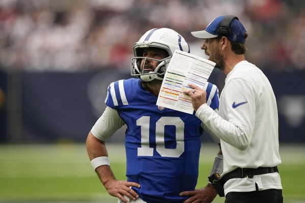 Indianapolis Colts quarterback Gardner Minshew II (10) gets a the play from head coach Shane Steichen in the first half of an NFL football game against the Houston Texans in Houston, Sunday, Sept. 17, 2023. (AP Photo/David J. Phillip)