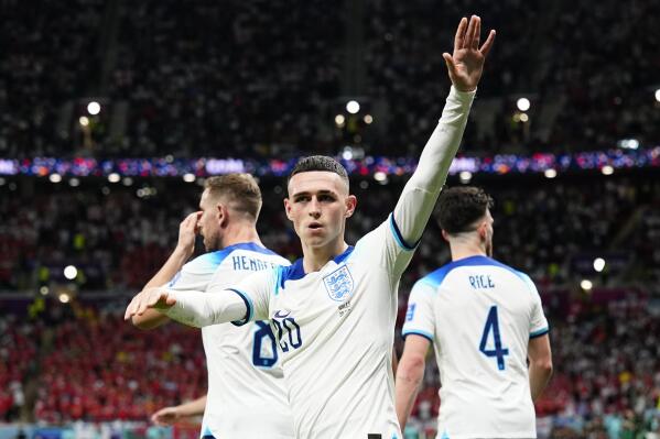 England's Phil Foden waves towards the fans after scoring his side's second goal during the World Cup group B soccer match between England and Wales, at the Ahmad Bin Ali Stadium in Al Rayyan, Qatar, Tuesday, Nov. 29, 2022. (AP Photo/Pavel Golovkin)