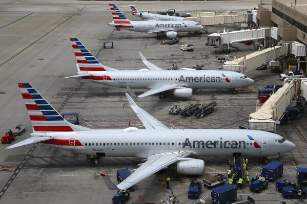 FILE - In this July 17, 2019 file photo American Airlines planes are parked on the tarmac at Phoenix Sky Harbor International Airport in Phoenix. American Airlines Group Inc. (AAL) on Thursday, April 22, 2021, reported a loss of $1.25 billion in its first quarter. (AP Photo/Ross D. Franklin, File)