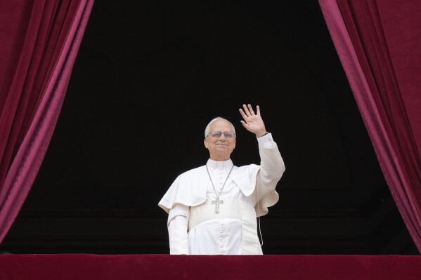 Pope Leo XIV appears at the central balcony of St. Peter's Basilica for his first Sunday blessing after his election, in St. Peter's Square at the Vatican, Sunday, May 11, 2025.(AP Photo/Gregorio Borgia)