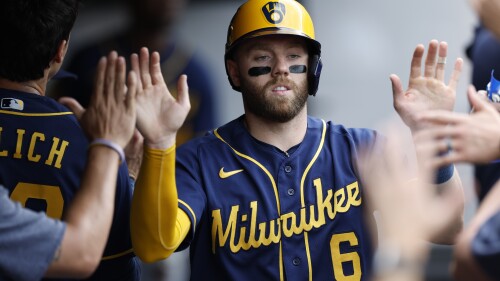 Milwaukee Brewers' Owen Miller celebrates in the dugout after scoring on a single by Rowdy Tellez off Cleveland Guardians starting pitcher Aaron Civale during the third inning of a baseball game, Sunday, June 25, 2023, in Cleveland. (AP Photo/Ron Schwane)