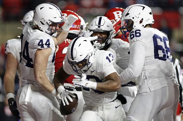 Penn State running back Kaytron Allen (13) is congratulated by teammates after scoring a touchdown against Rutgers during the second half of an NCAA college football game, Saturday, Nov. 19, 2022, in Piscataway, N.J. Penn State won 55-10. (AP Photo/Adam Hunger)