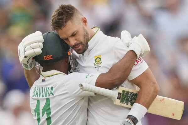 South Africa's Aiden Markram, right, celebrates with batting partner Temba Bavuma after scoring a century on day three of the World Test Championship final between South Africa and Australia at Lord's cricket ground in London, Friday, June 13, 2025. (AP Photo/Kirsty Wigglesworth)