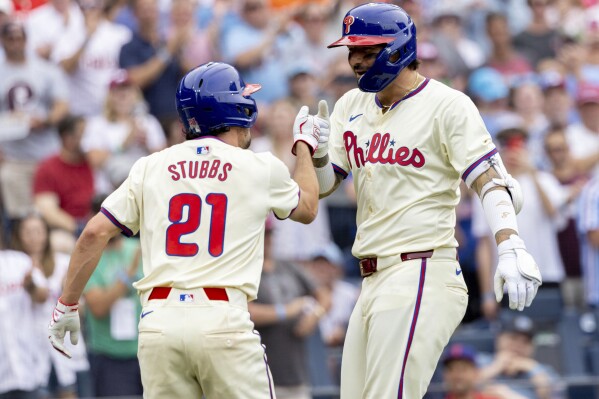 Philadelphia Phillies' Nick Castellanos, right, is congratulated by teammate Garrett Stubbs (21) after hitting a two-run home run during the sixth inning of a baseball game against the Milwaukee Brewers, Wednesday, June 5, 2024, in Philadelphia. (AP Photo/Laurence Kesterson)