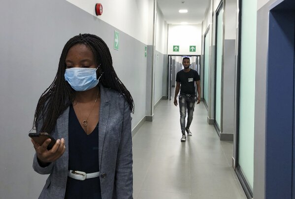 In Feb. 6, 2020, photo, a masked woman walks in a corridor of a shopping mall in Kitwe, Zambia. The coronavirus that has spread through much of China has yet to be diagnosed in Africa, but global health authorities are increasingly worried about the threat as health workers on the ground warn they are not ready to handle an outbreak. (AP Photo/Emmanuel Mwiche)