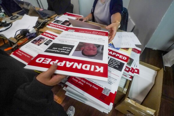 FILE - Posters of Israeli hostages being held by Hamas is handed out during a photo shoot for a visual project calling for their release, Wednesday, Nov. 1, 2023, in New York. While the posters were created to raise awareness and support, they've also angered others who are critical of Israel's actions and history in the conflict with Palestinians. (AP Photo/Bebeto Matthews, File)