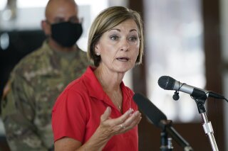 FILE - In this Aug. 14, 2020, file photo, Iowa Gov. Kim Reynolds speaks during a news conference, in Cedar Rapids, Iowa. Reynolds and four top Iowa officials cooperated in making a marketing video for a company that has received no-bid contracts during the state's coronavirus response. The arrangement between the state and Utah-based Domo Inc. has raised allegations of favoritism and improper use of public resources. (AP Photo/Charlie Neibergall, File)
