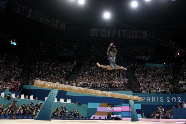 Simone Biles of the United States competes on the balance beam during a women's artistic gymnastics qualification round at the 2024 Summer Olympics, Sunday, July 28, 2024, in Paris, France. (AP Photo/Charlie Riedel)