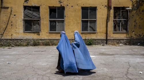 FILE - Afghan women wait to receive food rations distributed by a humanitarian aid group, in Kabul, Afghanistan, on May 28, 2023. The supreme leader of the Taliban released a message Sunday, June 25, claiming that his government has taken the necessary steps for the betterment of women's lives in Afghanistan, where women are banned from public life and work and girls' education is severely curtailed.(AP Photo/Ebrahim Noroozi, File)