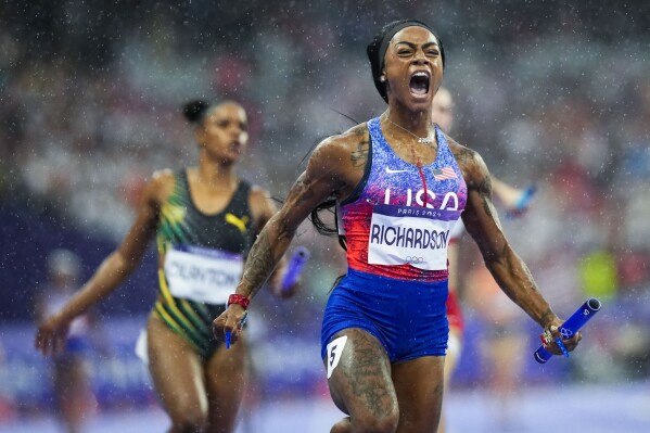 Sha'carri Richardson, of the United States, celebrates after winning the women's 4 x 100-meter relay final at the 2024 Summer Olympics, Friday, Aug. 9, 2024, in Saint-Denis, France. (AP Photo/Petr David Josek)